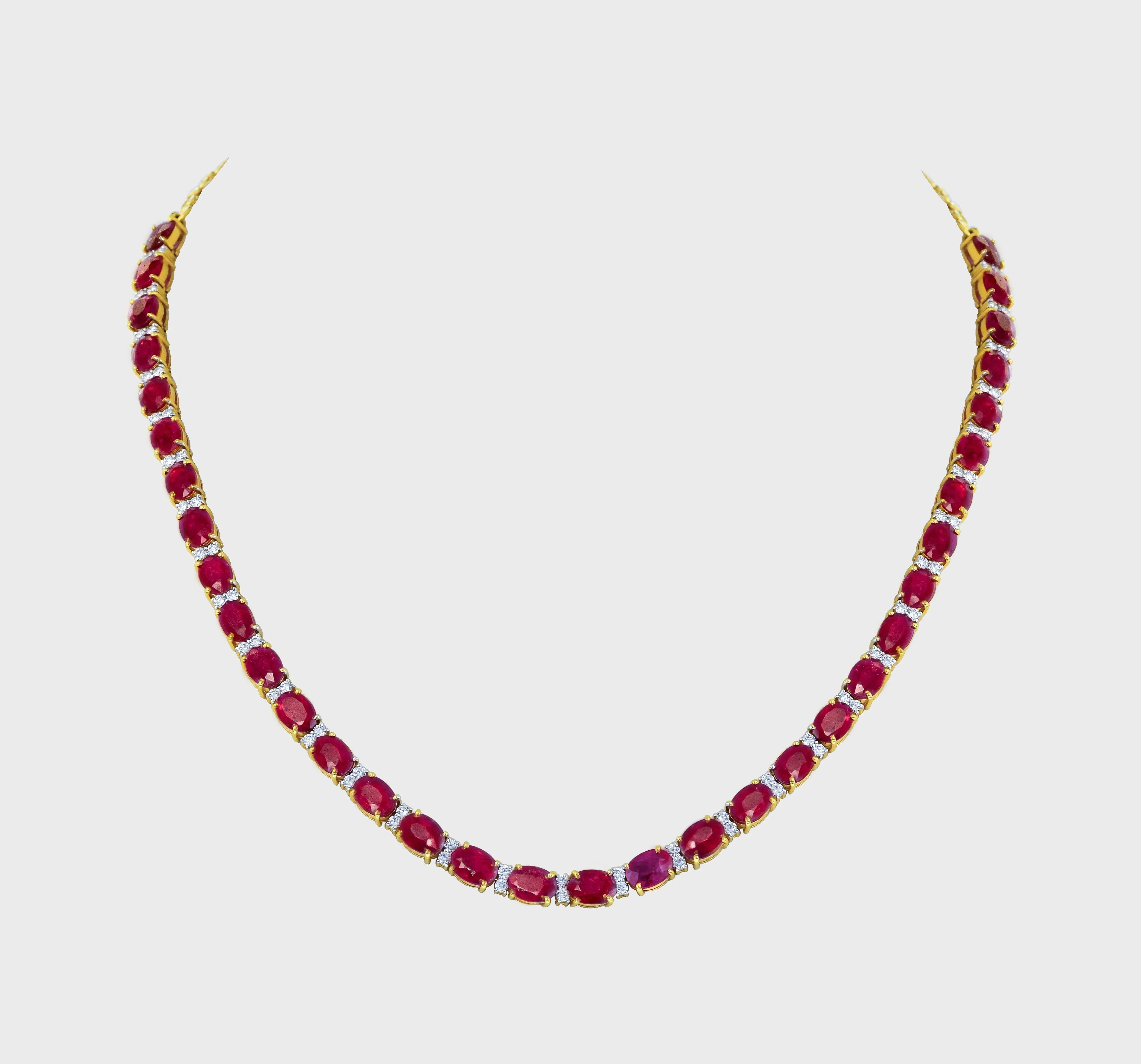 Elegance meets allure with our single line ruby and diamond necklace and earring pair. Crafted to perfection, each piece exudes timeless sophistication and luxury.