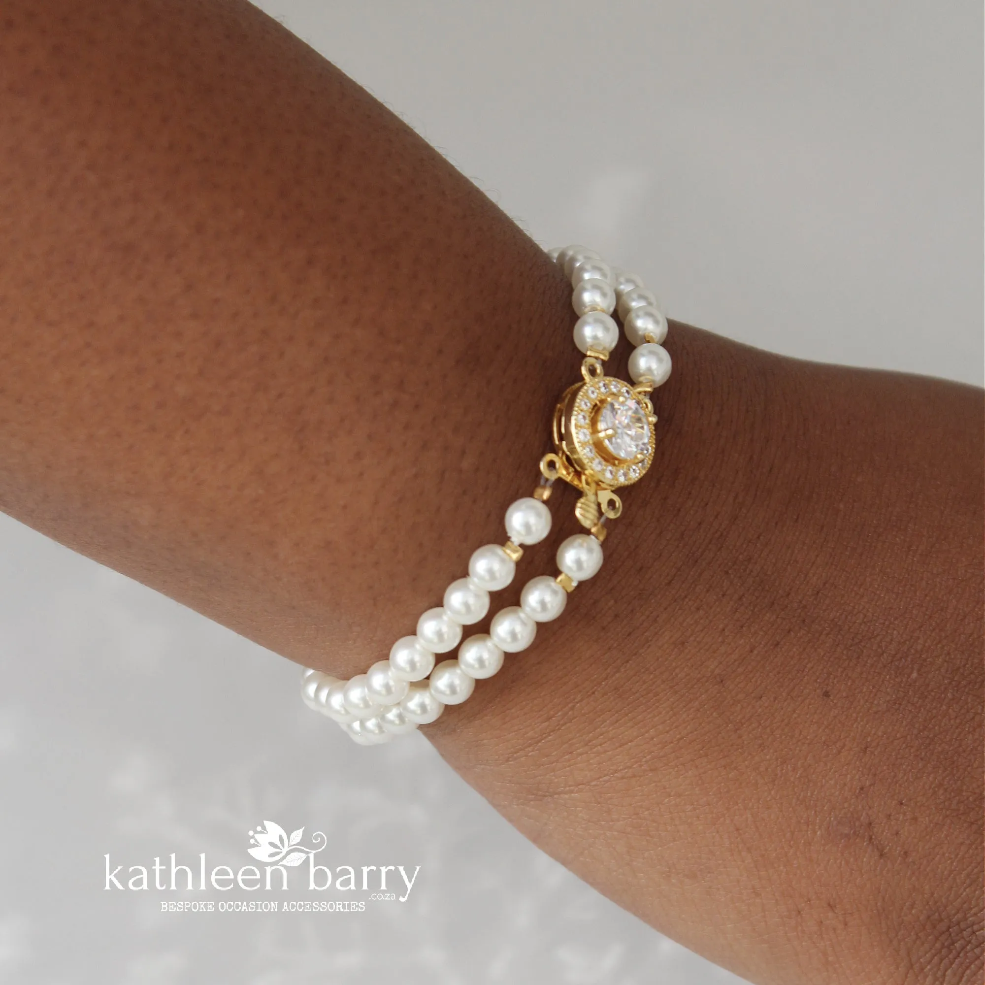 Ilke double strand pearl barecelet available in gold or rose gold 3 pearl color options